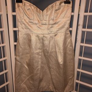 Golden strapless cocktail dress.